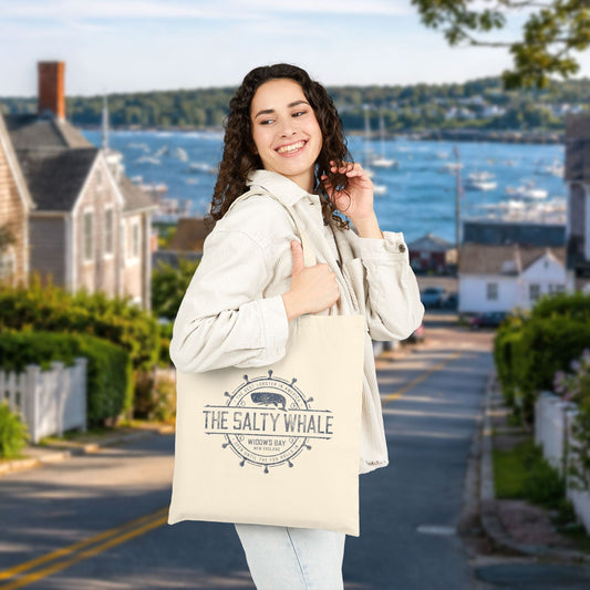 Person carrying natural canvas tote bag with vintage The Salty Whale, Widow's Bay TV show nautical grocery shopping