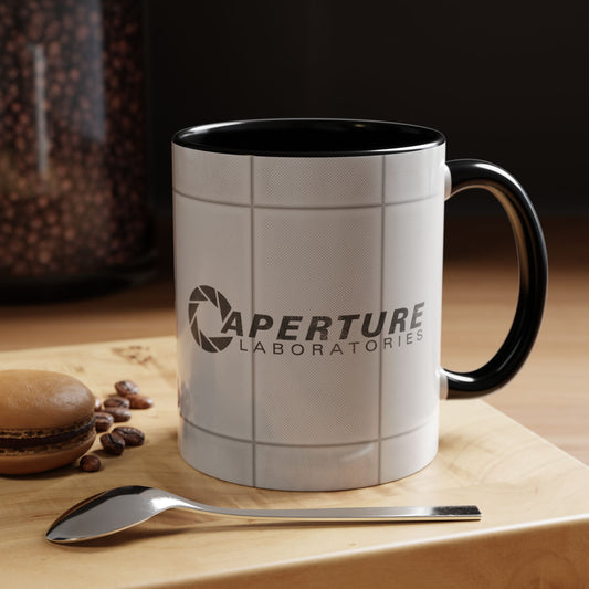 Black accent 11oz mug with Aperture Laboratories logo, Portal test chamber panel wall wrap, logo printed both sides, shown in a kitchen.