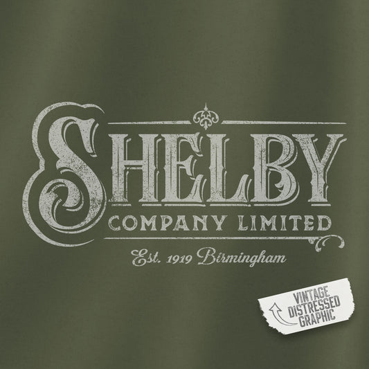 Closeup view of a Military Green colored Soft Unisex Hoodie Heavy Blend Hooded Sweatshirt featuring the fictional logo Shelby Company Limited from the TV series Peaky Blinders in a vintage distressed style.