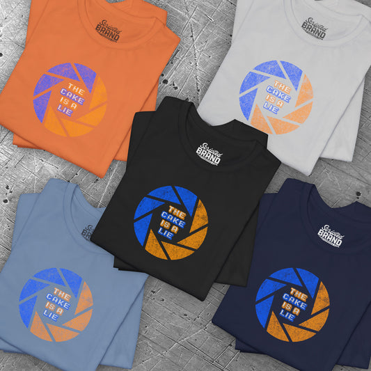 Group of 5 folded soft Bella+Canvas 3001 short-sleeve t-shirts featuring the phrase The Cake Is a Lie, along with the Aperture Laboratories shutter logo from the video game Portal and Portal 2 in a vintage distressed style, sold by ScriptedBrand.