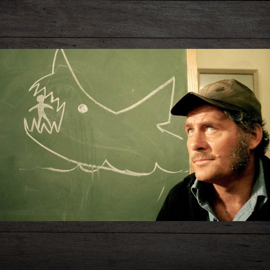 Scene from movie JAWS, a chalkboard drawing of a shark eating a person, drawn by Quint.