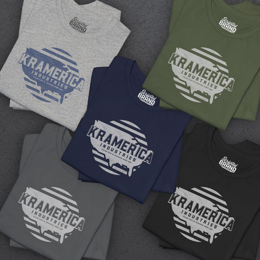 Five folded Bella+Canvas 3001 t-shirts featuring a unique Kramerica Industries logo graphic in a vintage distressed style, inspired by the TV show Seinfeld.