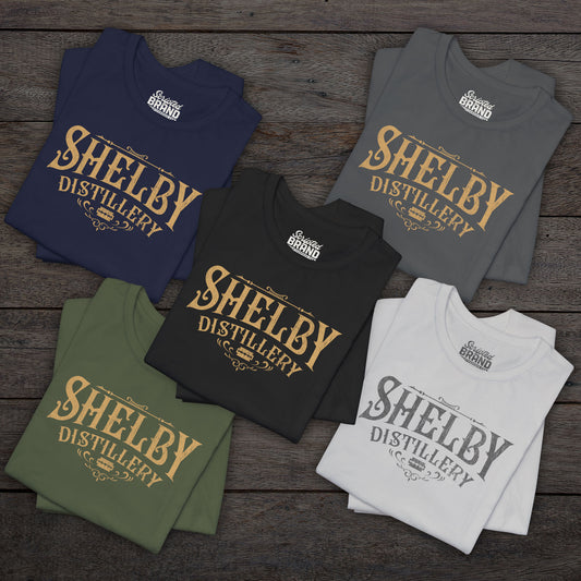 Group of 5 folded Soft Bella+Canvas 3001 short-sleeve t-shirts featuring the Shelby Company Limited Distillery Logo Graphic inspired by the TV show and movie Peaky Blinders in a vintage distressed style, sold by ScriptedBrand.