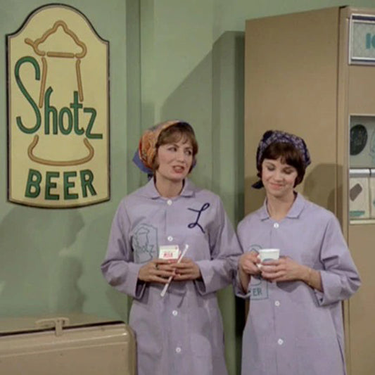 Scene from TV show Laverne & Shirley, with Shotz Beer Brewery logo graphic on wall in background.