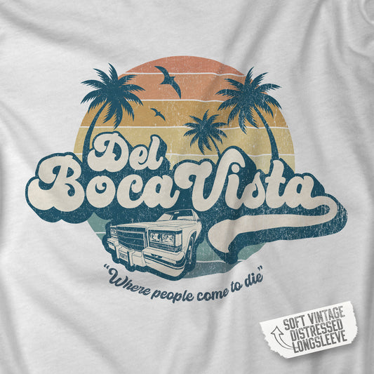 Closeup of a Soft Bella+Canvas 3501 long-sleeve t-shirt featuring a Del Boca Vista logo graphic (uniquely designed by ScriptedBrand), including the phrase Where People Come To Die, inspired by the TV show Seinfeld, in a vintage distressed style.
