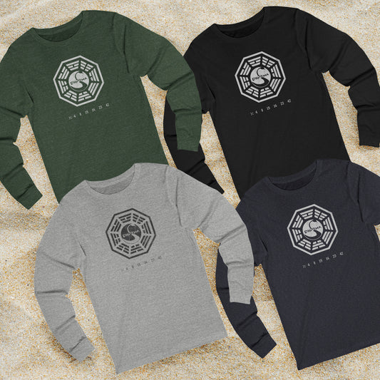 Four long sleeve t-shirts with distressed Dharma Initiative Swan Station logo and hatch numbers from LOST, shown on beach sand