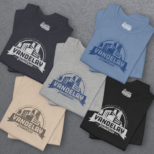 Group of 5 folded Soft Bella+Canvas 3001 short-sleeve t-shirts featuring a Vandelay Industries logo graphic, uniquely designed by ScriptedBrand in a vintage distressed style. The fictional company is part of the George Costanza storyline in the TV show Seinfeld.
