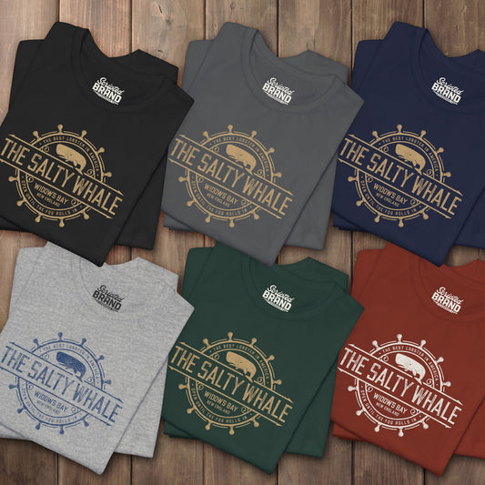 Six folded 'The Salty Whale' vintage distressed pub logo t-shirt inspired by Widow's Bay Apple TV series, soft Bella+Canvas cotton tee