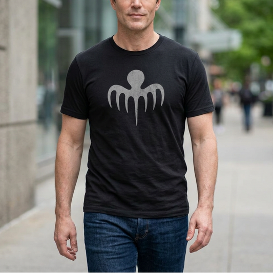 Man wearing black tee with vintage distressed gray Spectre octopus emblem James Bond-inspired graphic