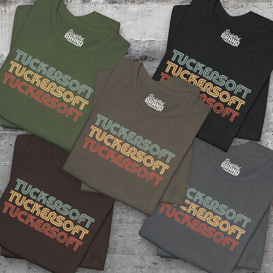 Group of 5 folded soft Bella+Canvas 3001 short-sleeve t-shirts and tees featuring a logo graphic of the 1980s fictional video game company Tuckersoft inspired by the TV show Black Mirror and the episode Bandersnatch in a vintage distressed style, sold by ScriptedBrand.