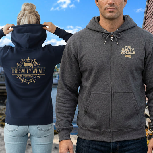 Two people wearing Gildan full-zip hoodies with Widow's Bay Salty Whale logo on front and gold distressed maritime crest across the back