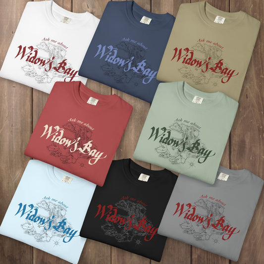 Eight folded Comfort Colors tees with a vintage island map and antique "Ask Me About Widow's Bay" type from the Apple TV show