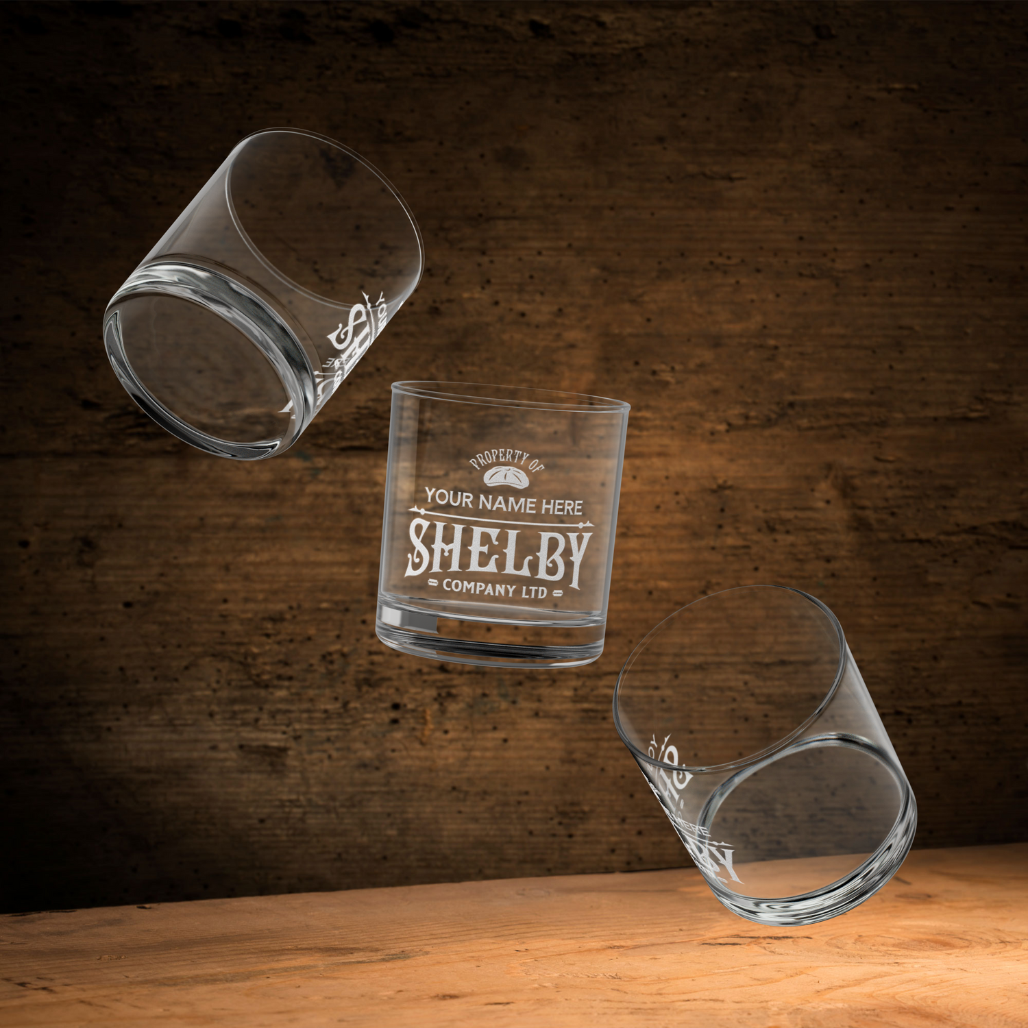 Three floating Personalized 10 oz rocks glass with Shelby Company Limited Peaky Blinders inspired logo and custom name.