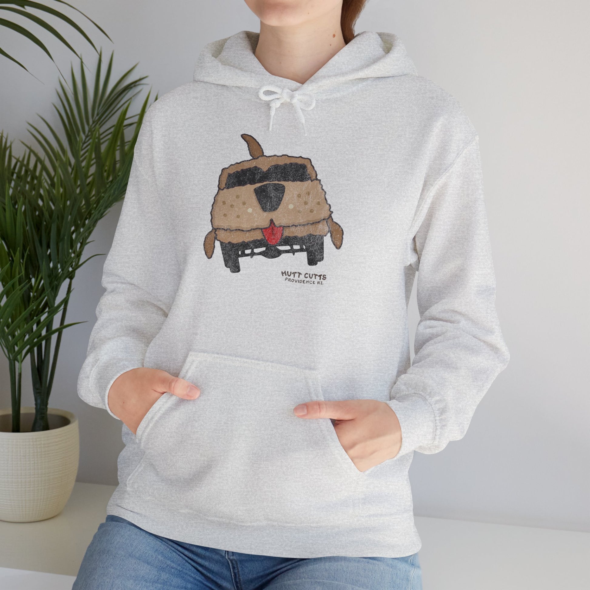 Woman wearing ash colored Gildan 18500 hoodie with vintage distressed Mutt Cutts dog van graphic inspired by Dumb and Dumber movie.