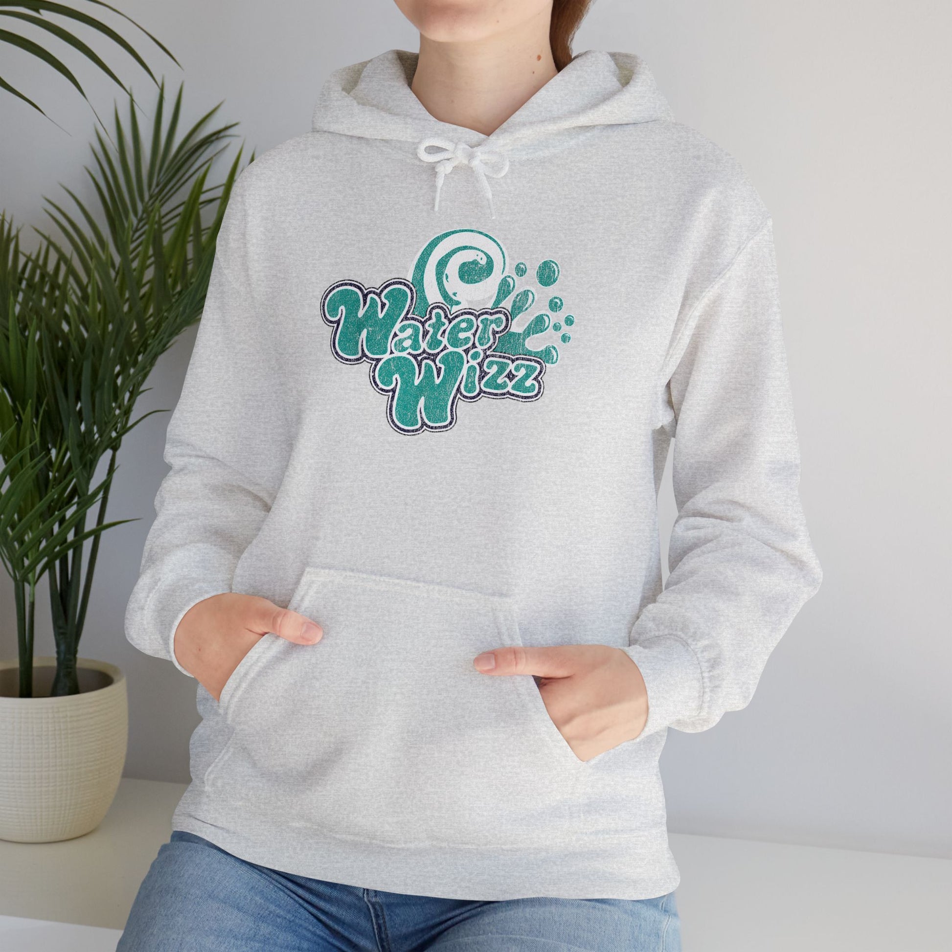 Woman wearing ash gray Gildan 18500 pullover hoodie with vintage distressed Water Wizz logo from Grown Ups on the chest.