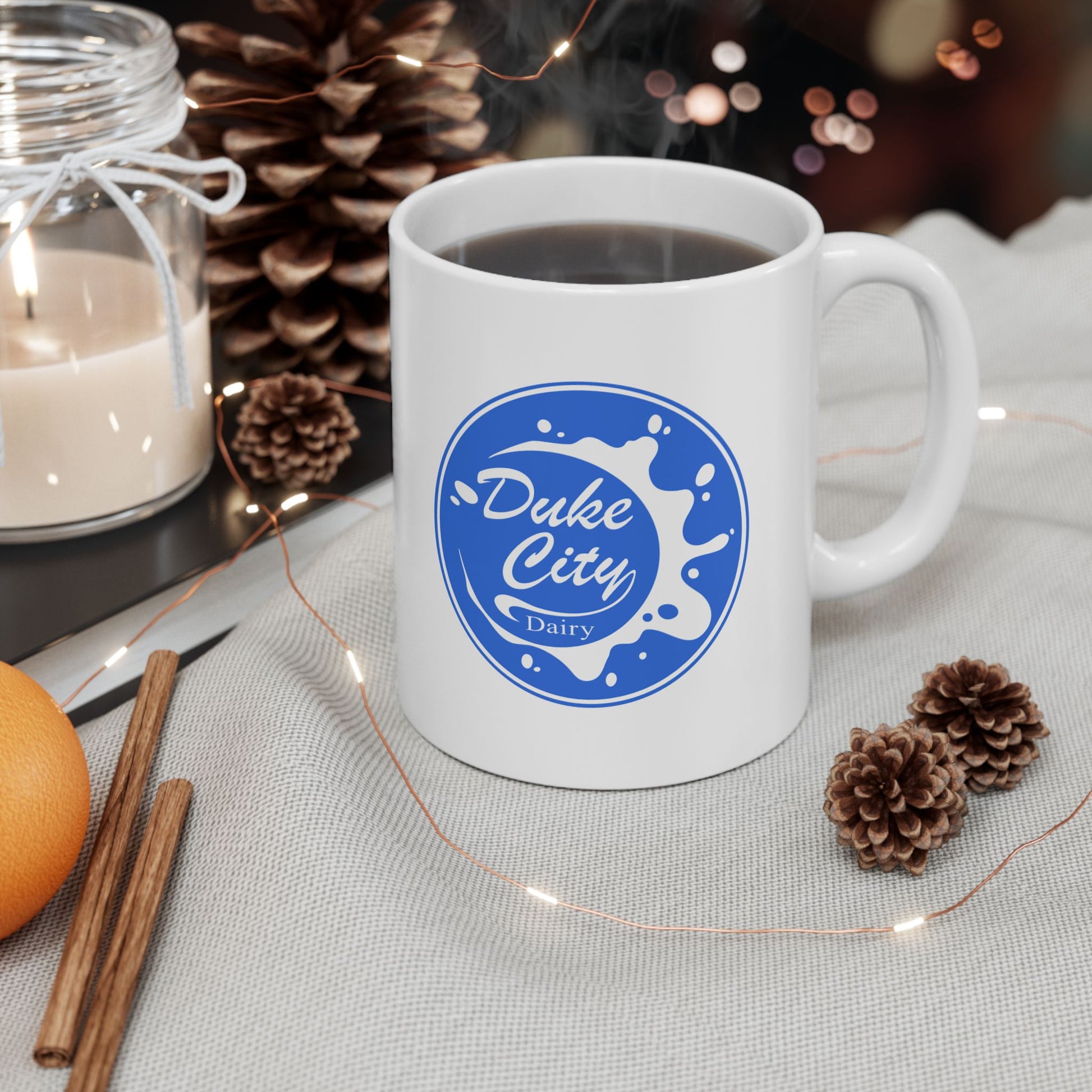 White mug with 'Duke City Dairy' logo from Pluribus on a table with decorative items