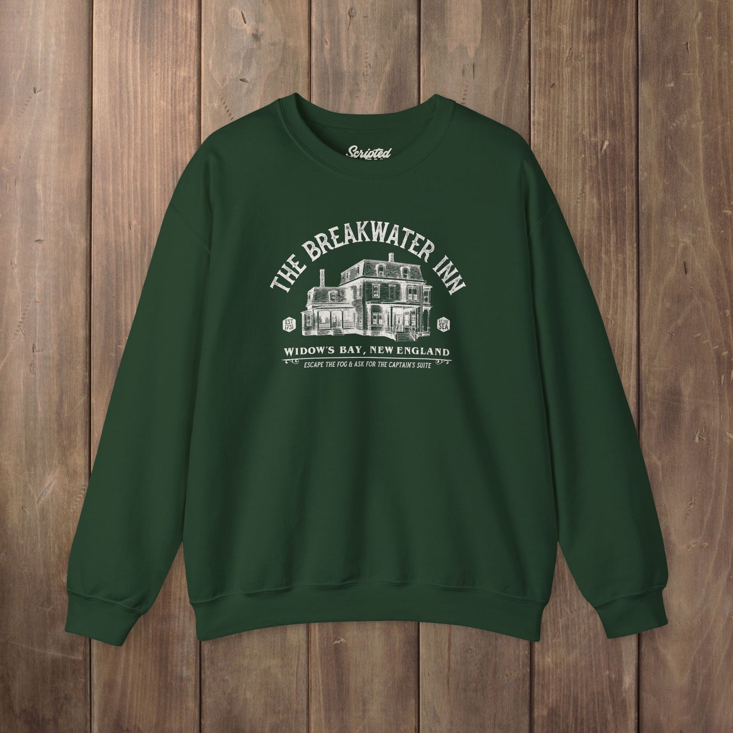 Forest green crewneck sweatshirt with Breakwater Inn Widow's Bay New England hotel graphic