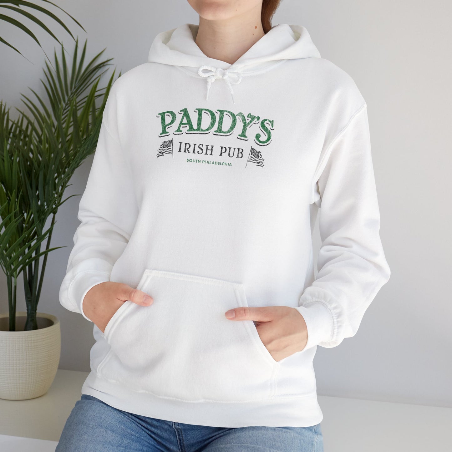 Woman wearing White Hoodie Sweatshirt with the Paddy's Pub logo graphic from the TV Show Its Always Sunny in Philadelphia in a vintage style.