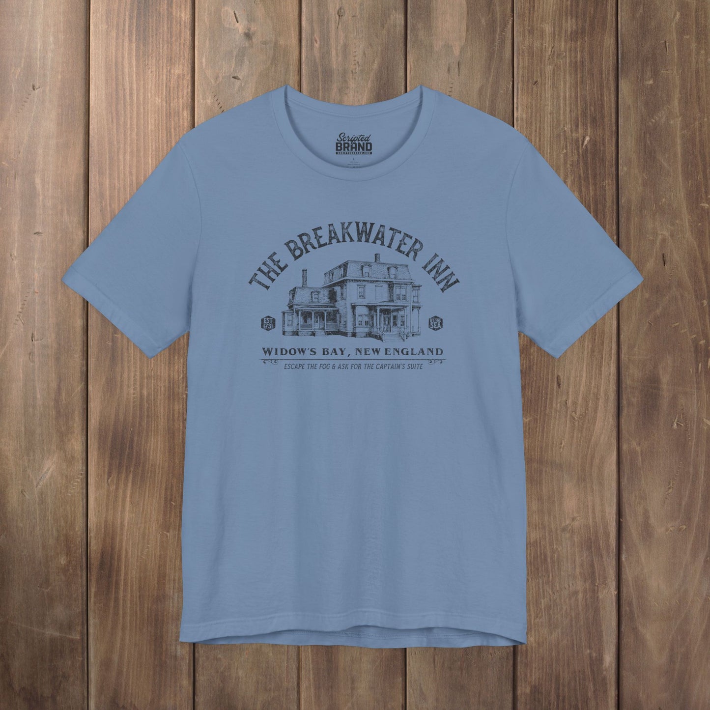 Steel blue 'The Breakwater Inn' vintage illustrated t-shirt inspired by Widow's Bay Apple TV series, soft Bella+Canvas cotton fan tee