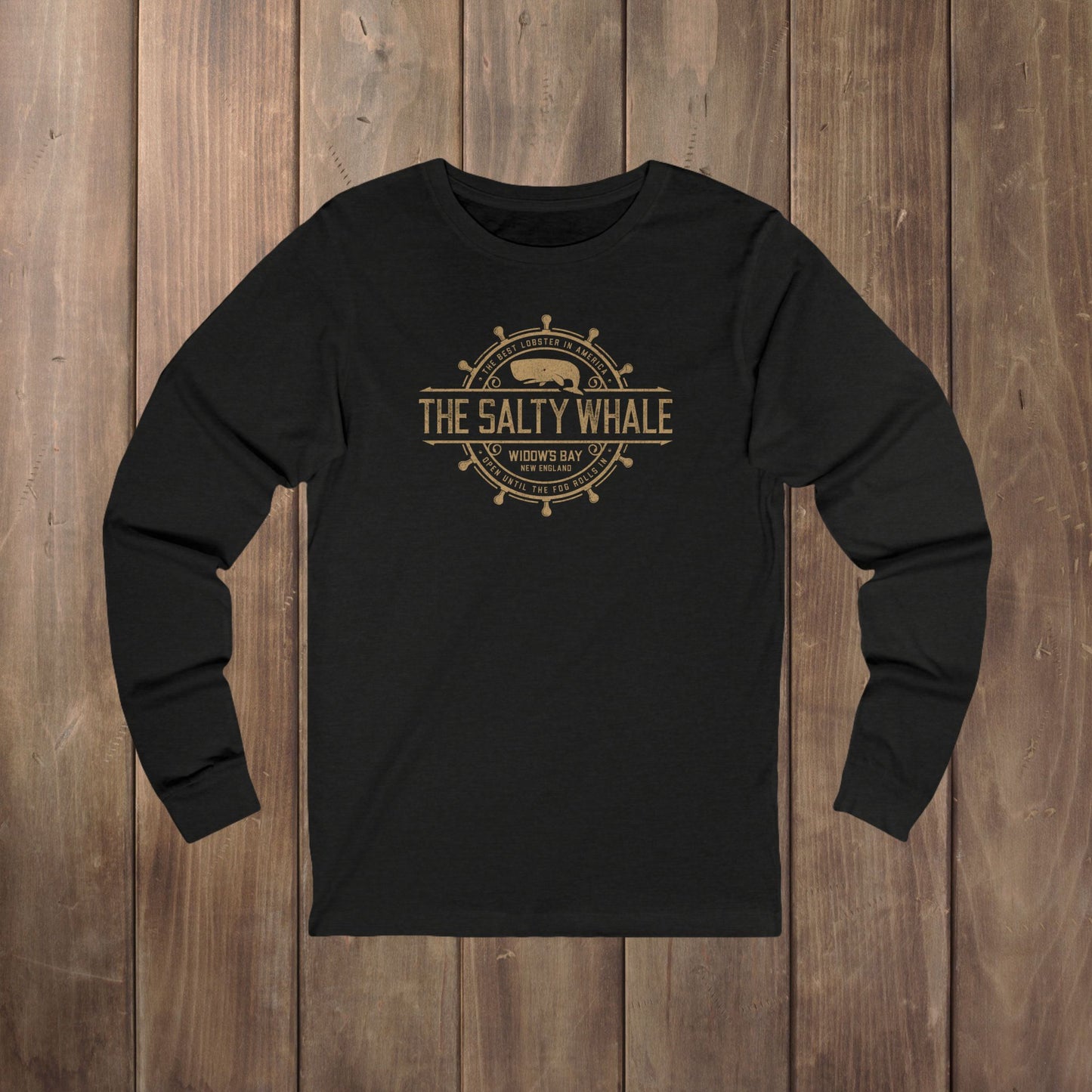 Heather black long-sleeve tee with the gold distressed Salty Whale maritime crest logo from Widow's Bay, New England