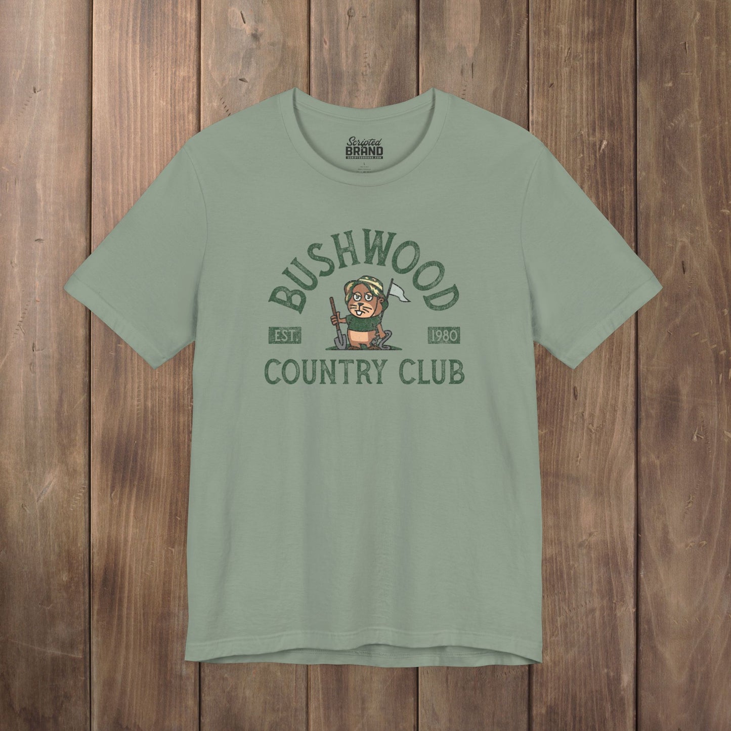 Sage Green Bella+Canvas tee with a vintage distressed Bushwood Country Club golf gopher logo from Caddyshack