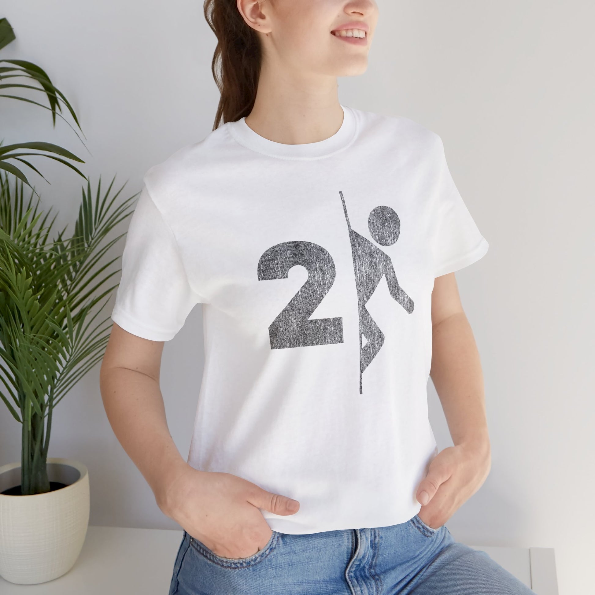 Woman wearing white tee with vintage distressed Portal 2 partial logo figure diving through a portal, aperture labs