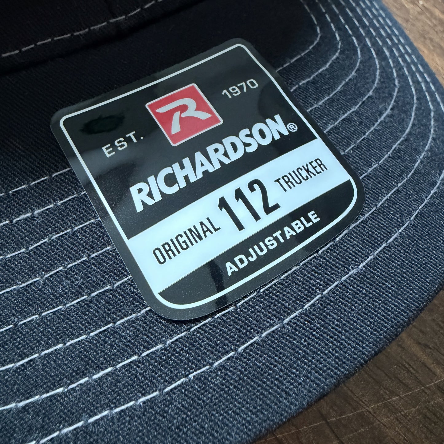 Close-up of a lid tag on a Richardson 112 Snapback Trucker Cap Baseball Hat sold by ScriptedBrand.
