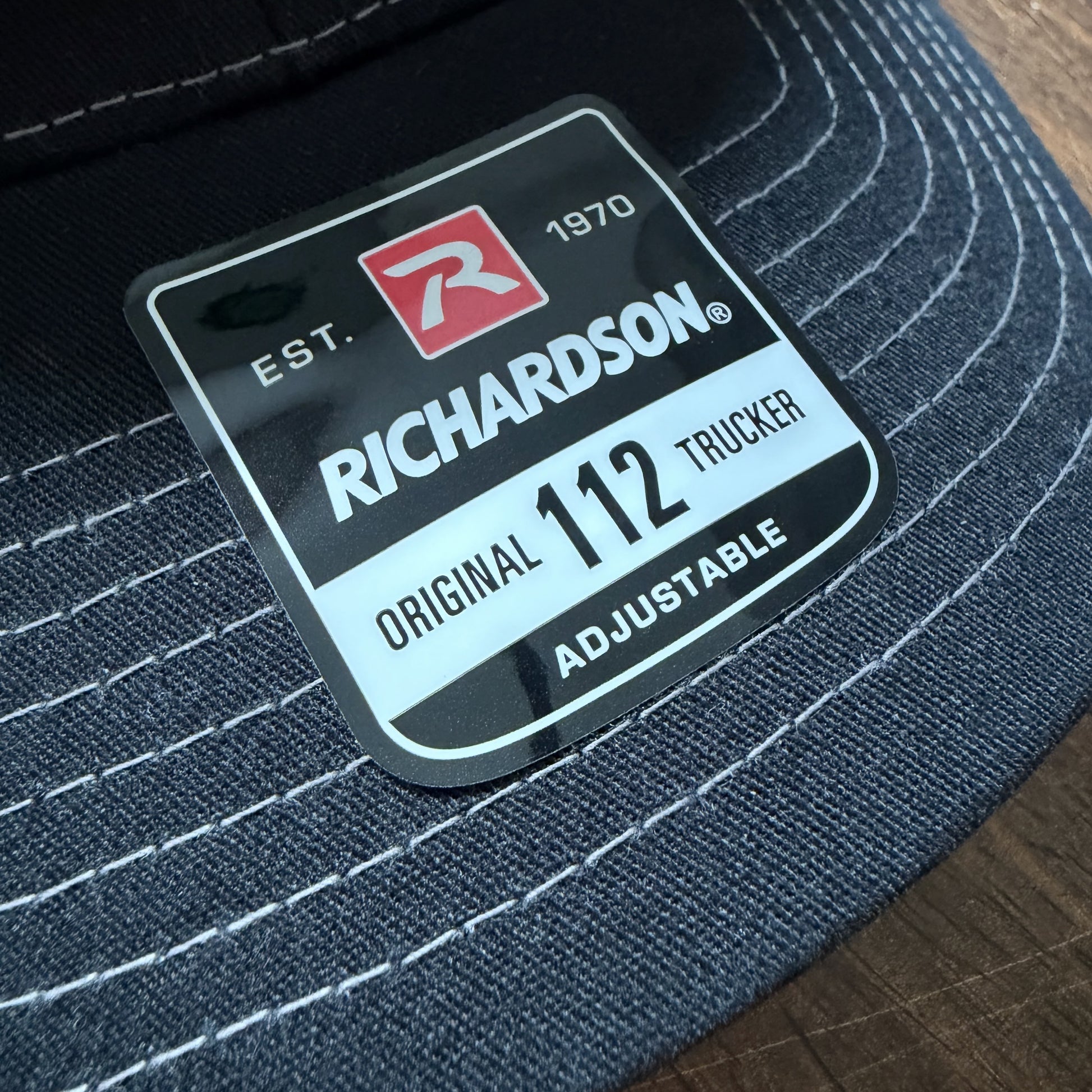 Close-up of a lid tag on a Richardson 112 Snapback Trucker Cap Baseball Hat sold by ScriptedBrand.