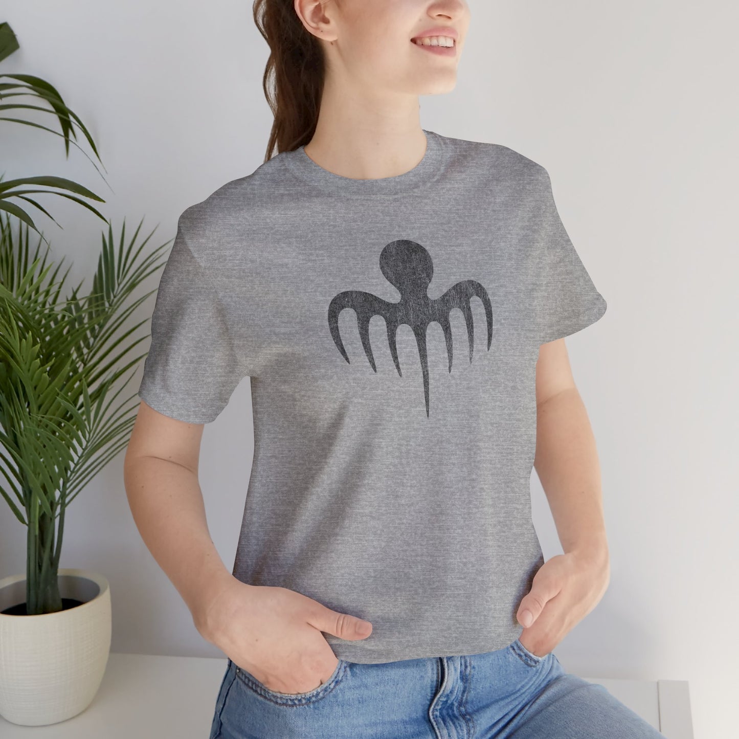 Person wearing Heather gray tee with vintage distressed black Spectre octopus emblem James Bond-inspired graphic