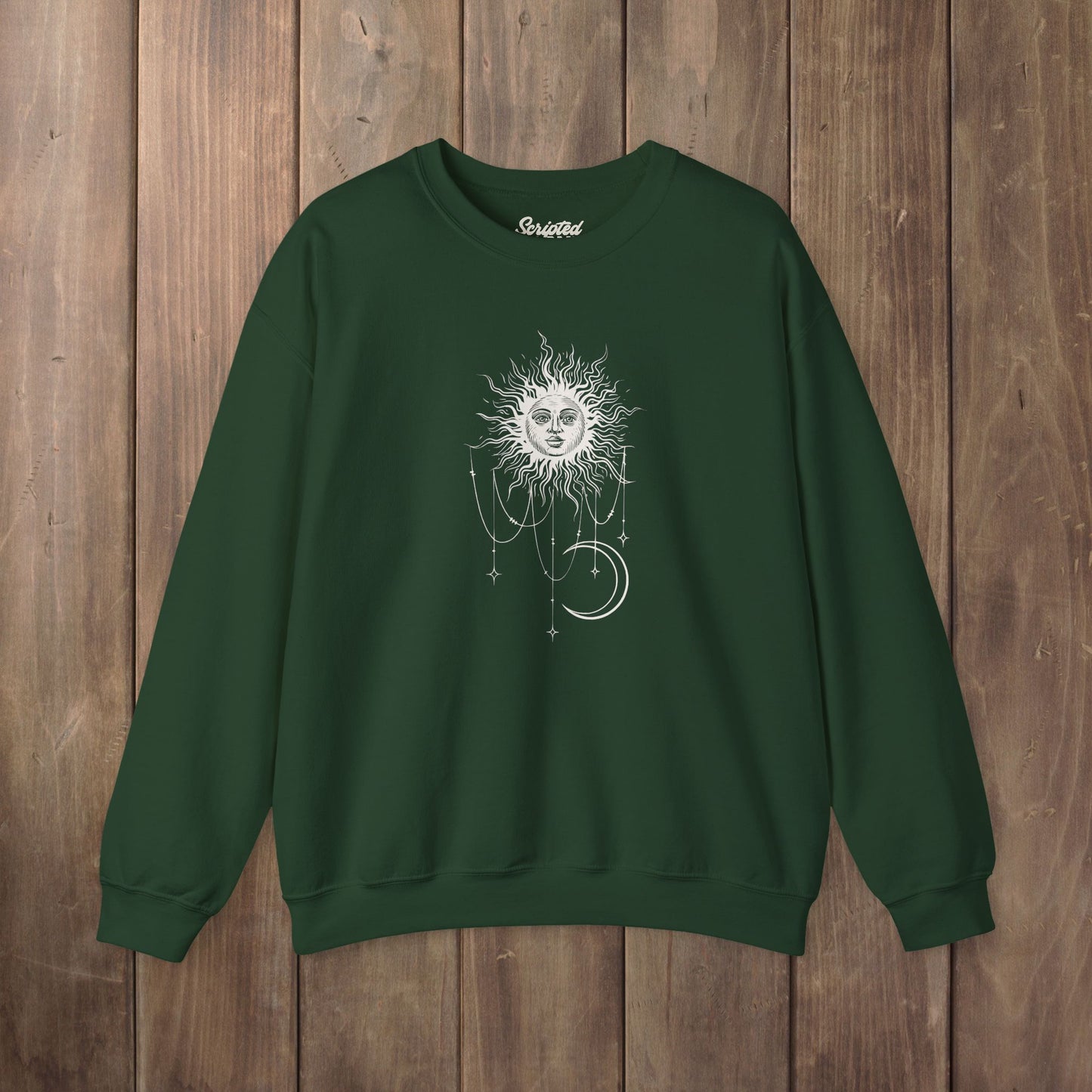 Forest green crewneck sweatshirt with boho celestial sun face, stars, and crescent moon design worn by Patricia in Widow's Bay