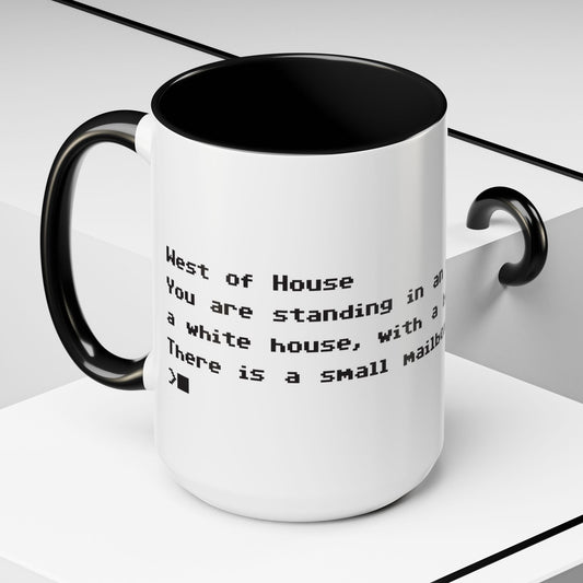 Angled view of 15 oz White ceramic accent mug with black handle and interior, Zork “West of House” opening line text wrapped in black print