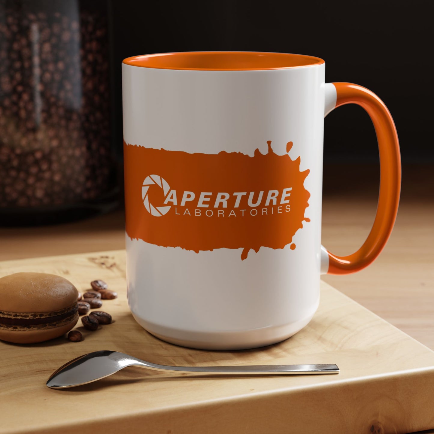 Kitchen view of 15oz Portal 2 Aperture Laboratories orange Propulsion Gel accent mug with orange handle, glossy ceramic.