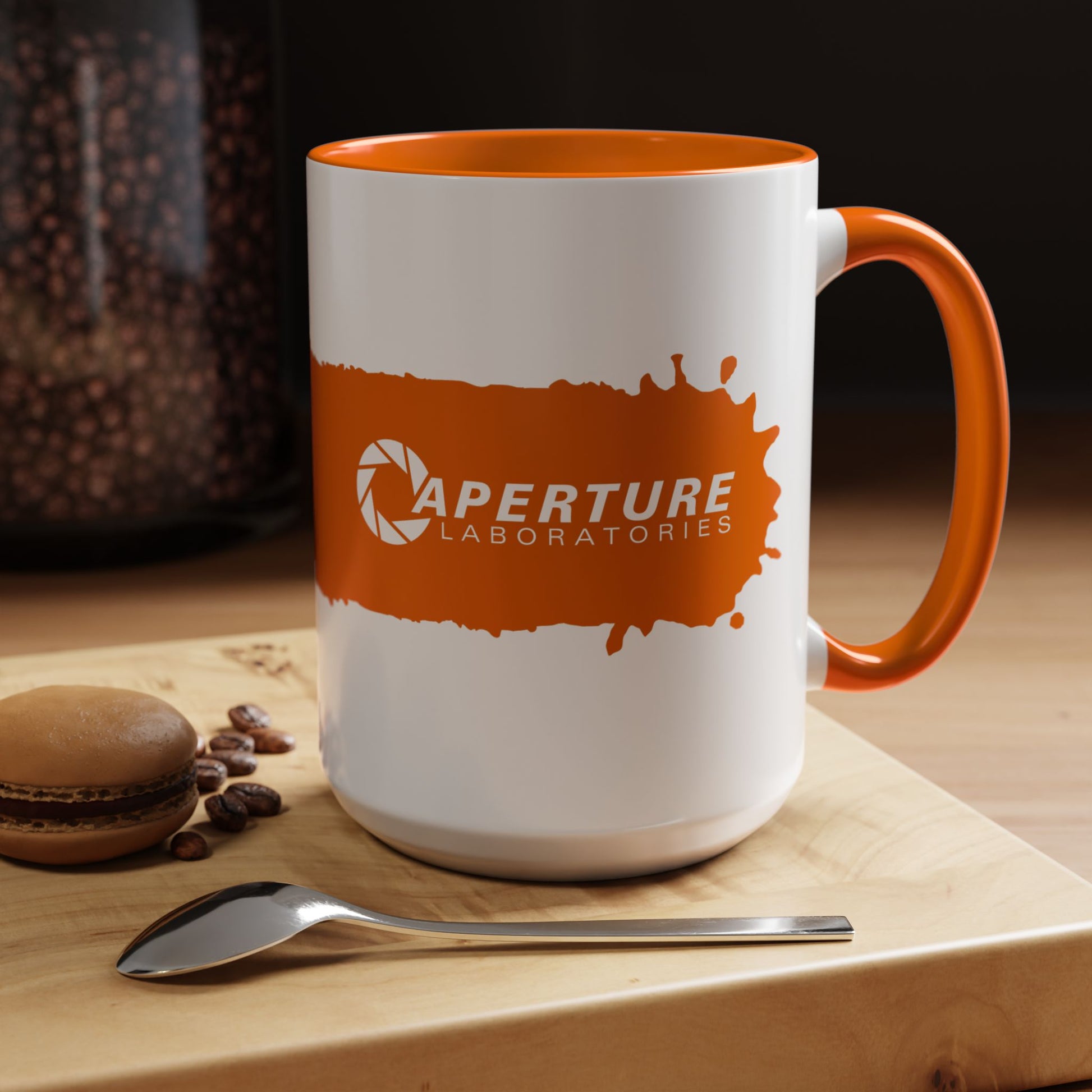 Kitchen view of 15oz Portal 2 Aperture Laboratories orange Propulsion Gel accent mug with orange handle, glossy ceramic.