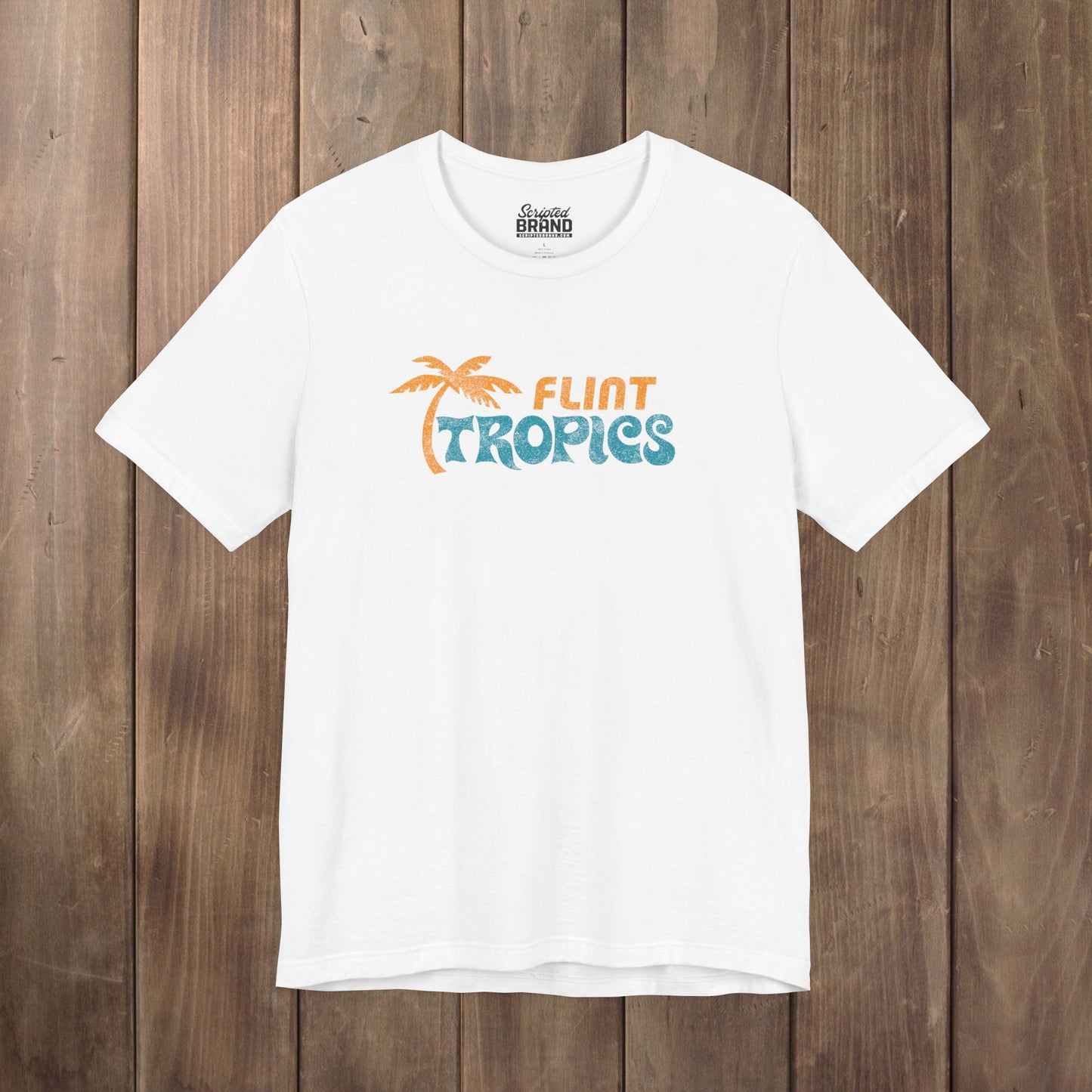 White Bella+Canvas t-shirt with the Flint Tropics logo from the movie Semi-Pro in a vintage distressed style.