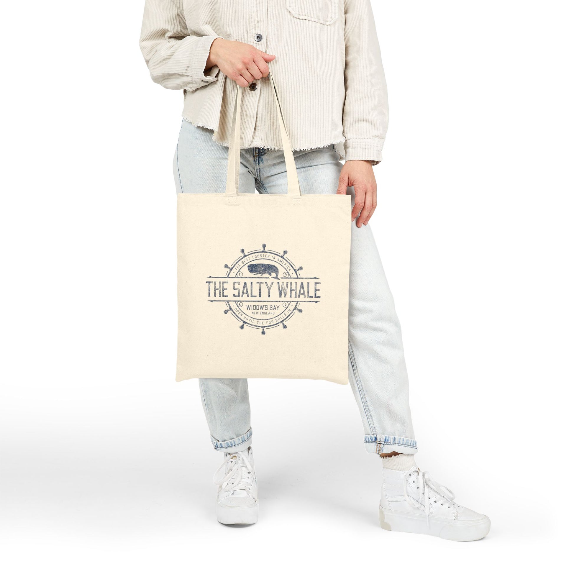 Person holding natural canvas tote bag with vintage The Salty Whale, Widow's Bay TV show nautical grocery shopping