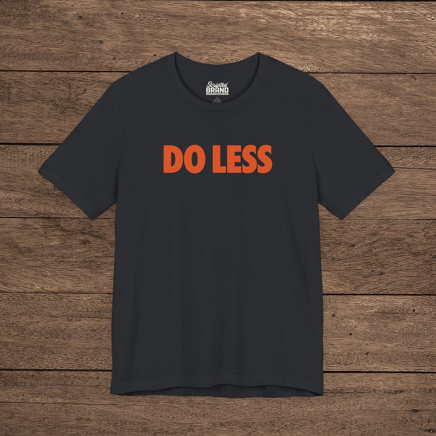 Vintage Black colored 'Do Less' graphic t-shirt inspired by Shrinking TV show, Bella+Canvas cotton tee with orange type