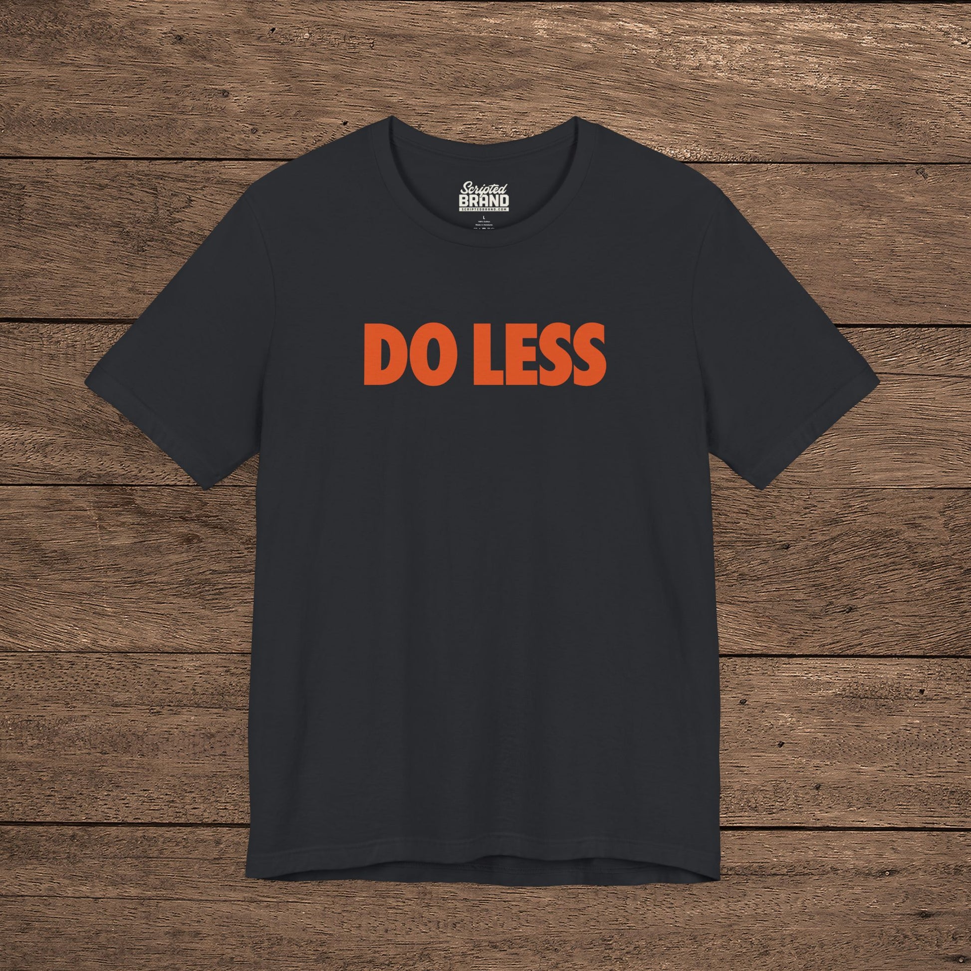 Vintage Black colored 'Do Less' graphic t-shirt inspired by Shrinking TV show, Bella+Canvas cotton tee with orange type