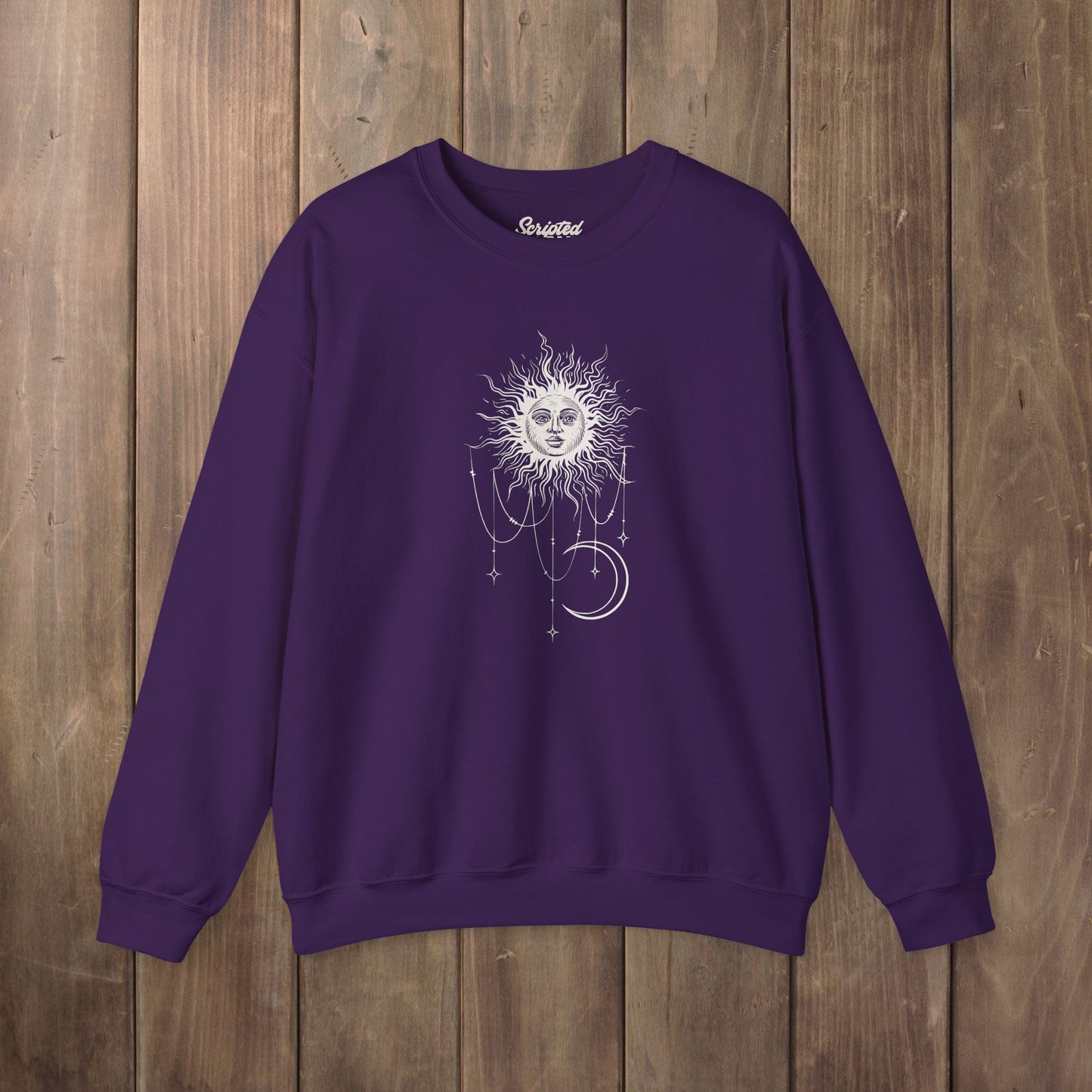 Purple crewneck sweatshirt with boho celestial sun face, stars, and crescent moon design worn by Patricia in Widow's Bay