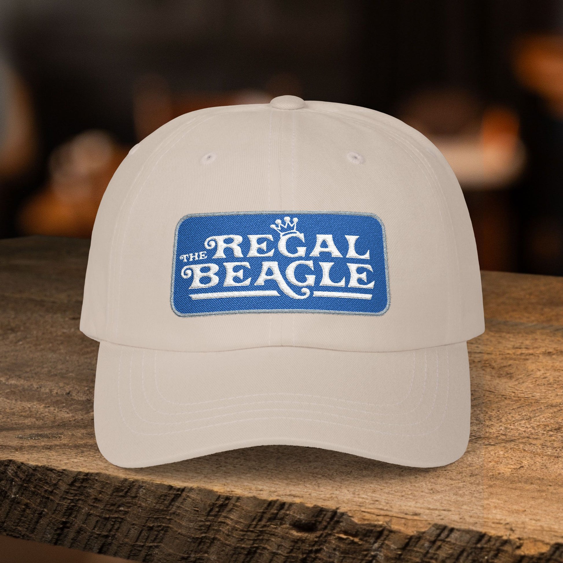 Stone dad cap with embroidered Regal Beagle patch logo, Three's Company inspired fictional bar merch

