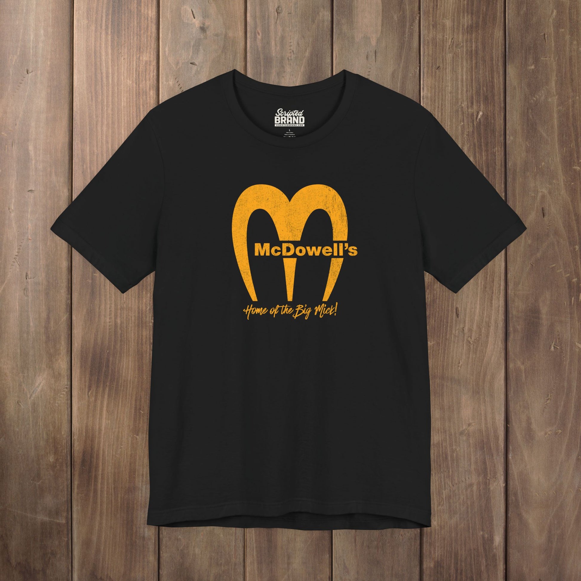 Black Bella+Canvas t-shirt featuring the McDowells logo from the movie Coming to America in a vintage distressed style.