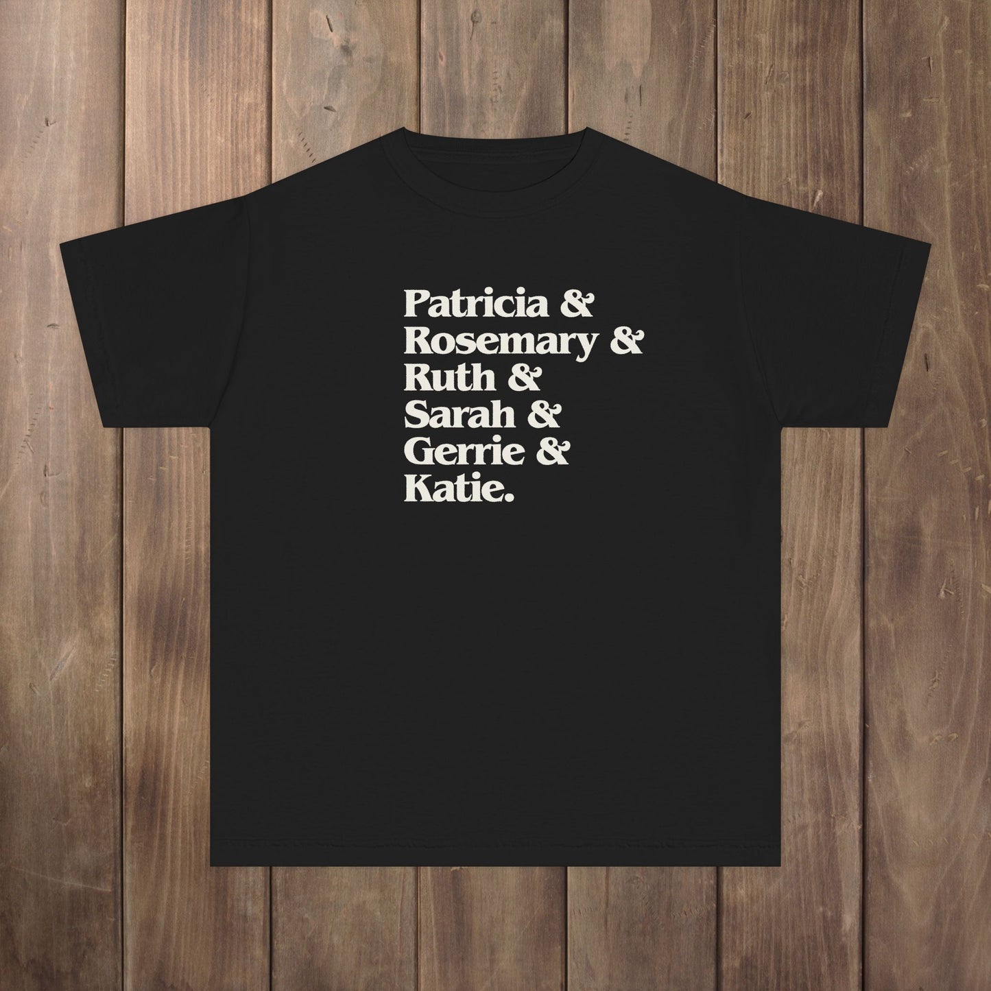 Black youth kids tee with stacked Women of Widow's Bay names in cream type