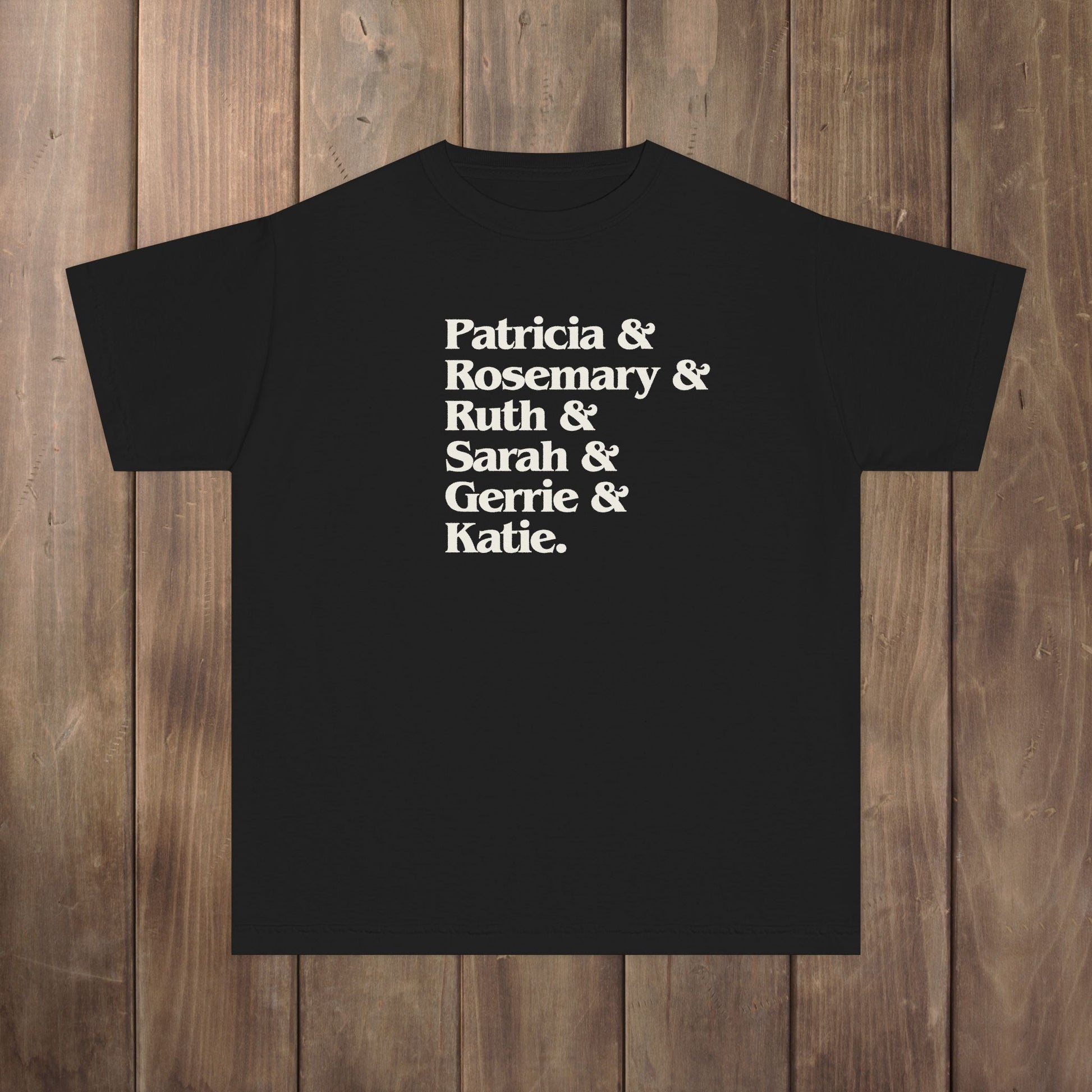 Black youth kids tee with stacked Women of Widow's Bay names in cream type