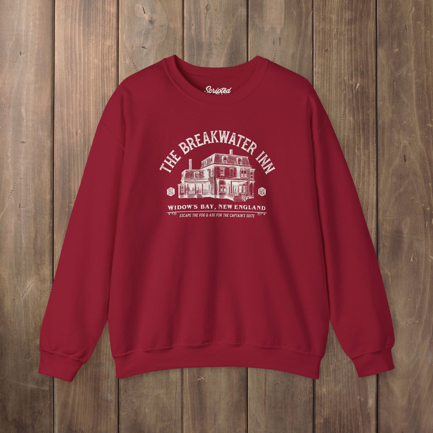 Red crewneck sweatshirt with Breakwater Inn Widow's Bay New England hotel graphic