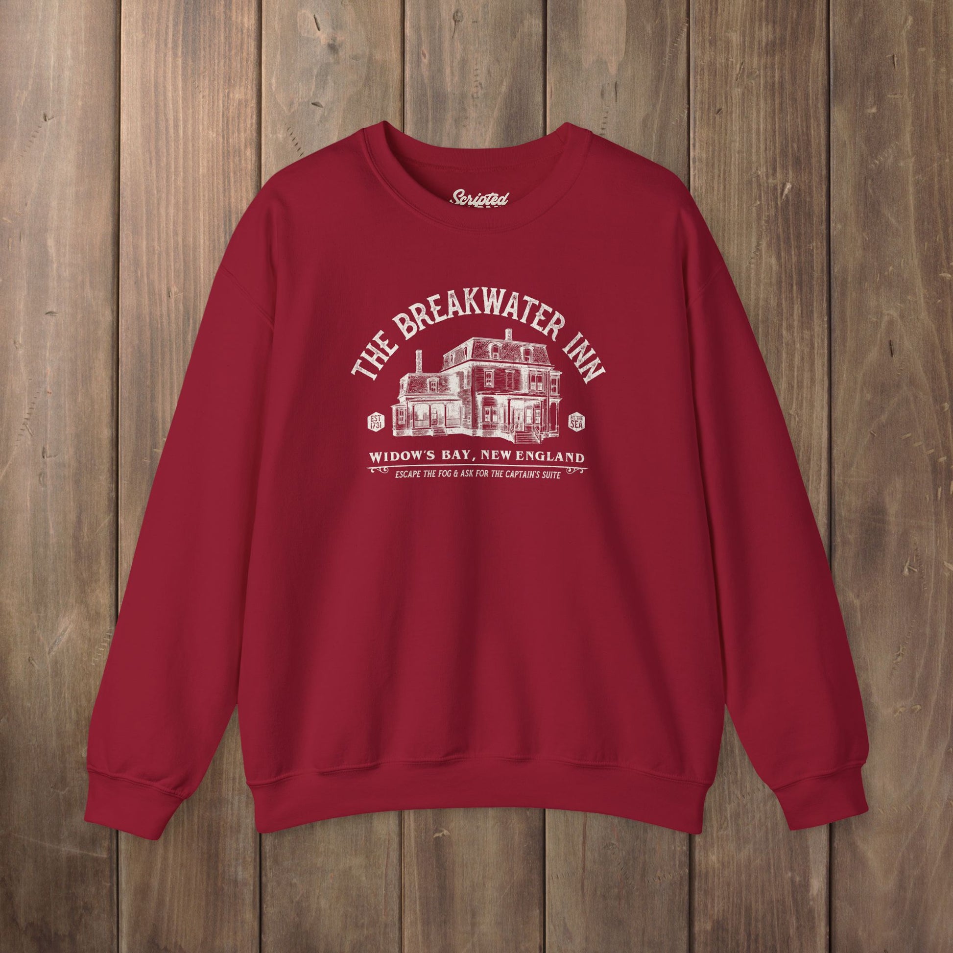 Red crewneck sweatshirt with Breakwater Inn Widow's Bay New England hotel graphic