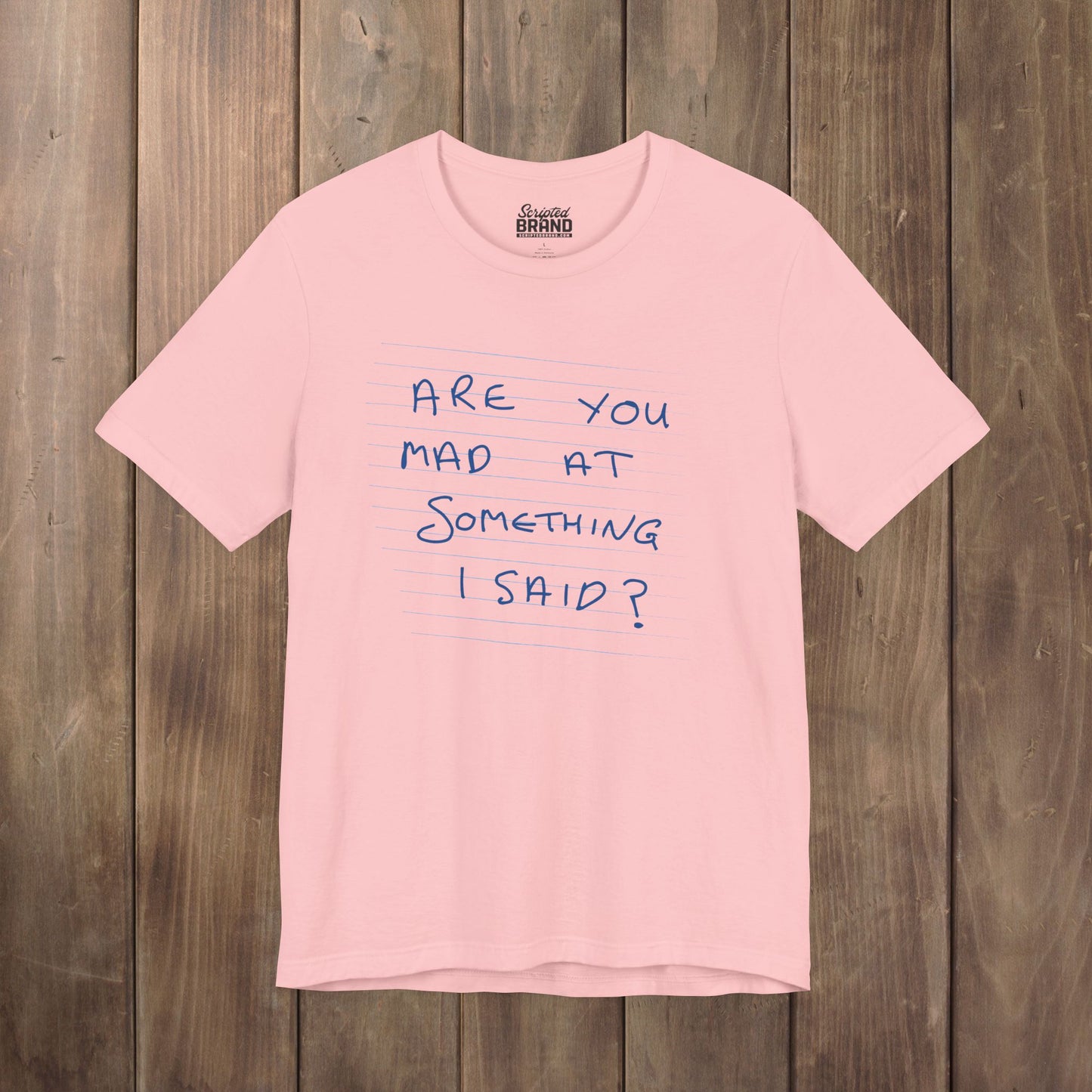Pink t-shirt with handwritten Patricia note from Widow's Bay reading "Are You Mad At Something I Said?"