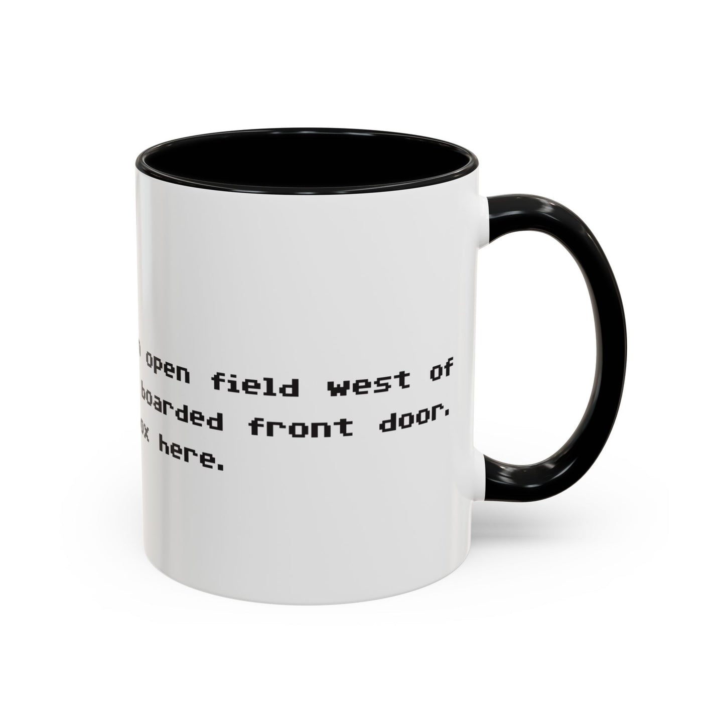 Right handle view of 11 oz White ceramic accent mug with black handle and interior, Zork “West of House” opening line text wrapped in black print