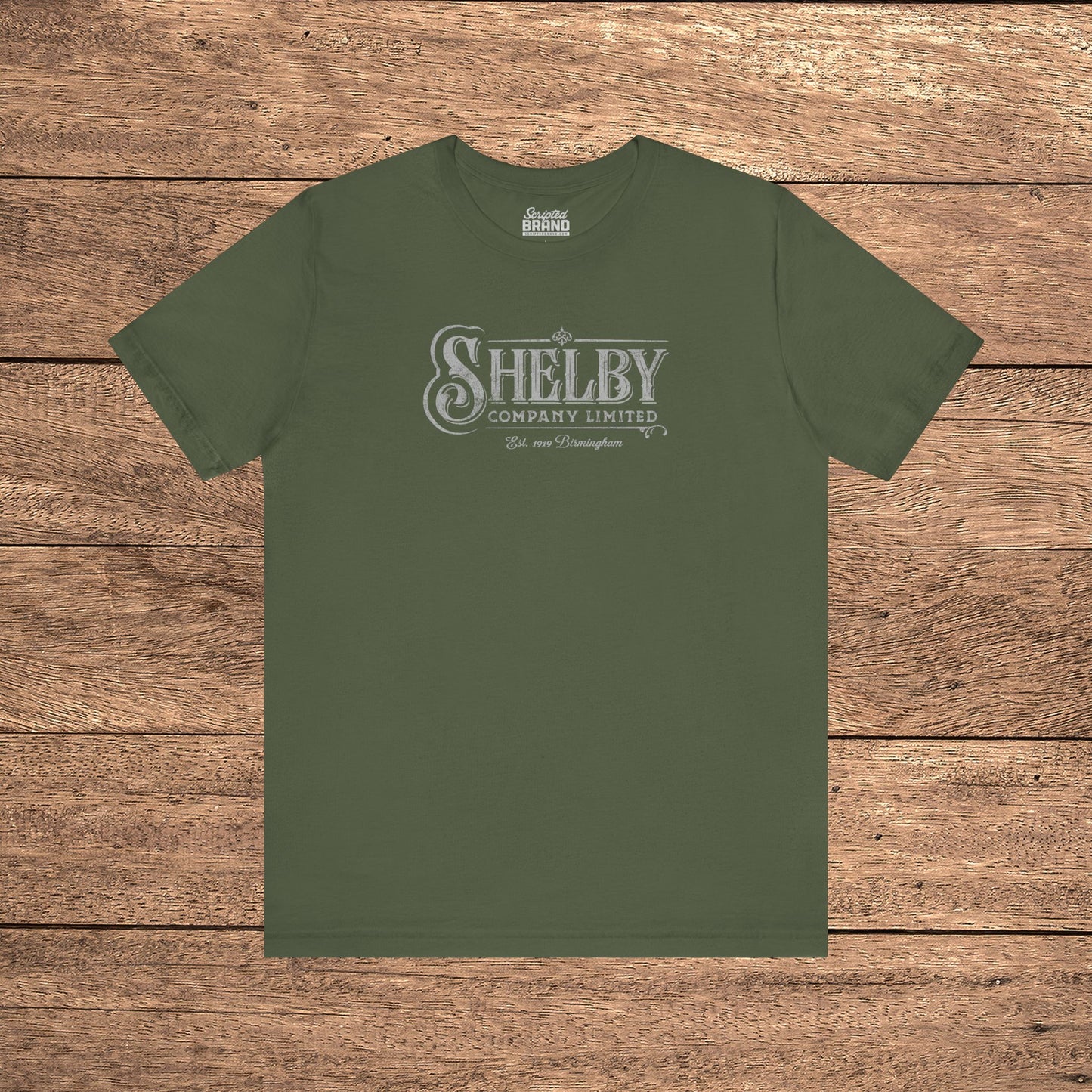 Military green Bella+Canvas 3001 t-shirt featuring a vintage Shelby Company Limited logo from Peaky Blinders.