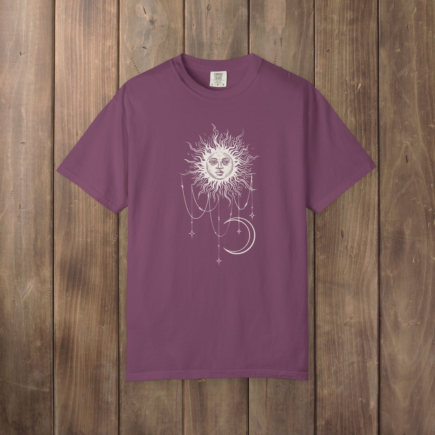Berry purple Comfort Colors tee with a celestial sun and crescent moon design, worn by Patricia in Widow's Bay S1E8