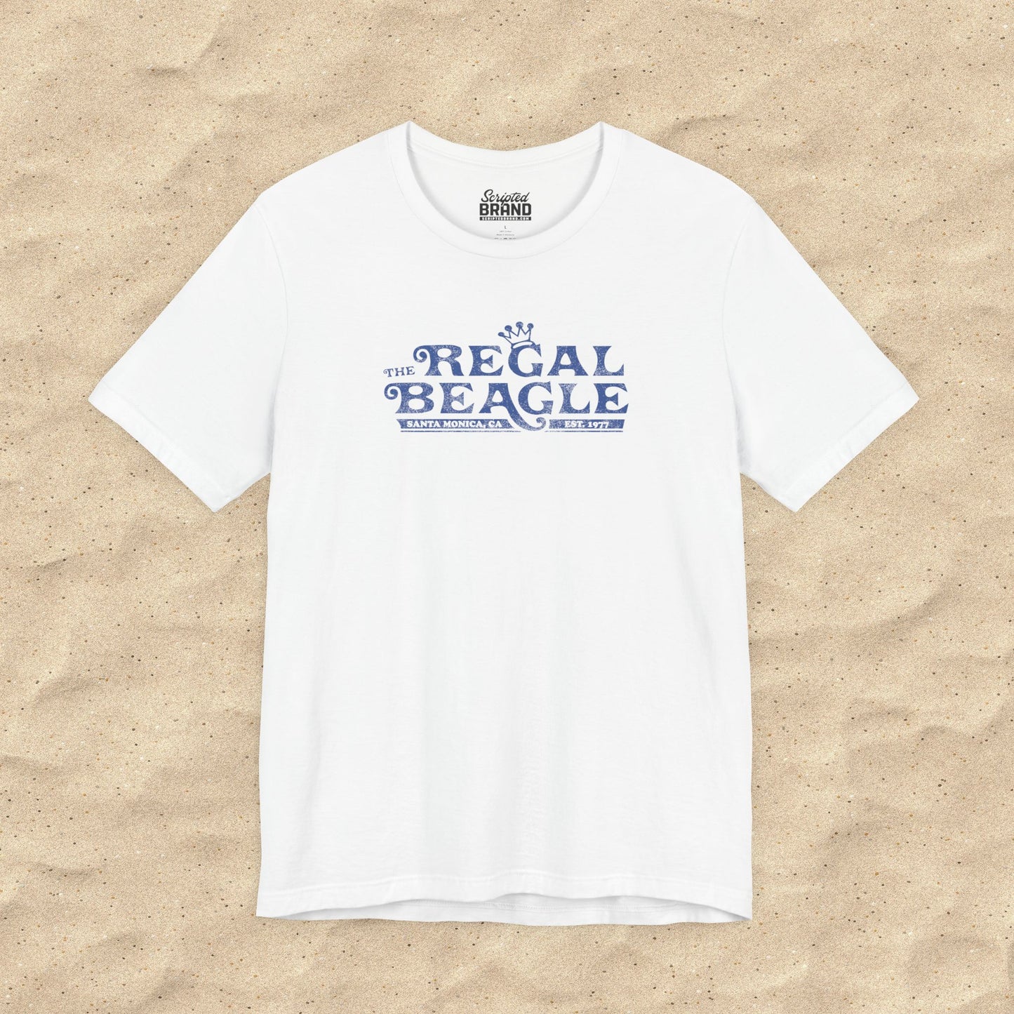White Bella+Canvas t-shirt with the Regal Beagle logo from the TV Show 'Threes Company' in a vintage distressed style.