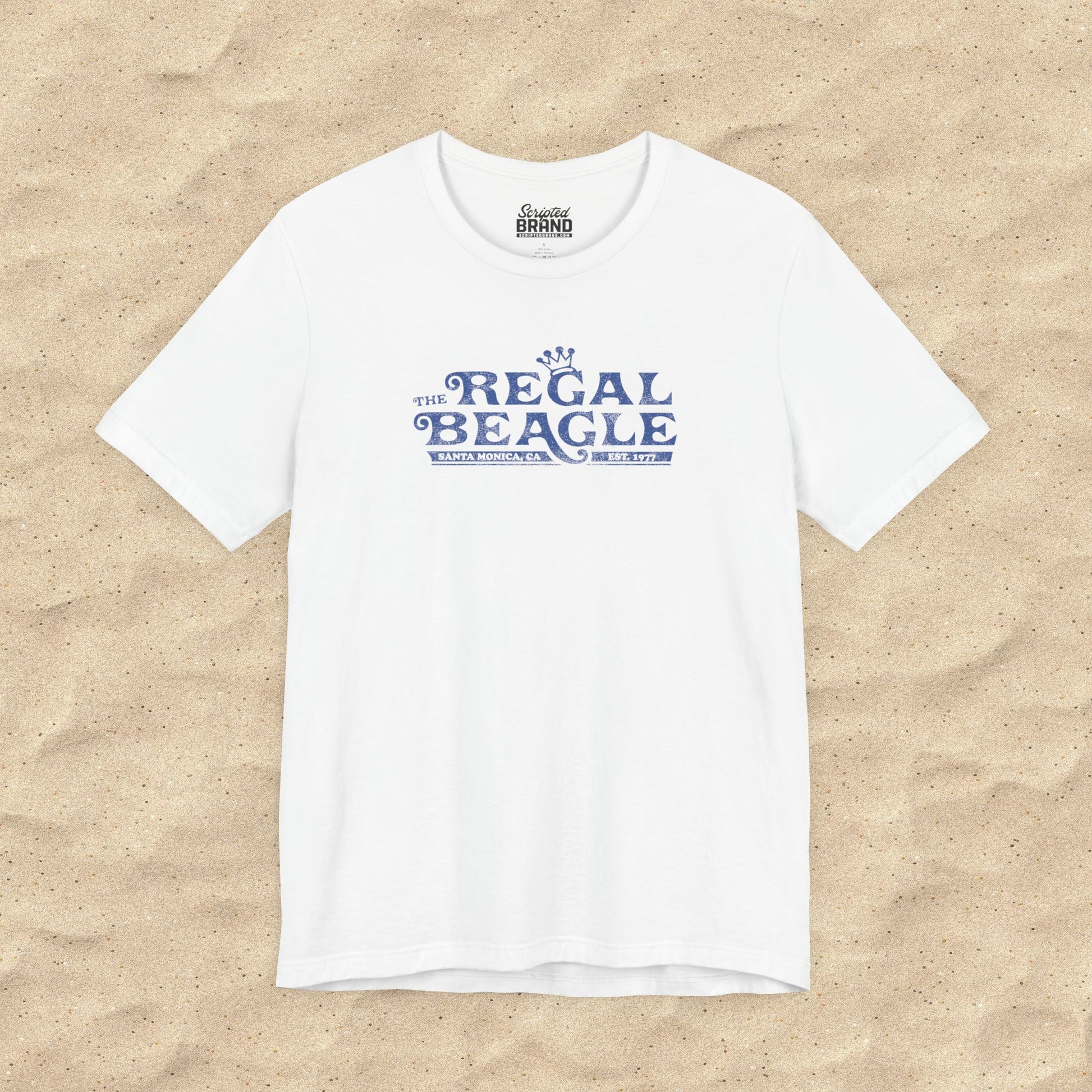 White Bella+Canvas t-shirt with the Regal Beagle logo from the TV Show 'Threes Company' in a vintage distressed style.
